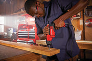 Photo of Craftsman CMED731 corded drill used on wood plank in workshop setting.